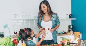 Mother and child preparing a salad