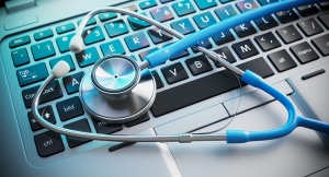 Stethoscope on computer laptop