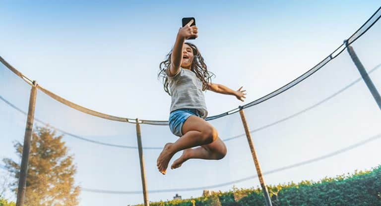 Child jumping on trampoline