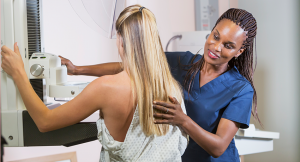 Woman receiving a breast examination from a health care provider